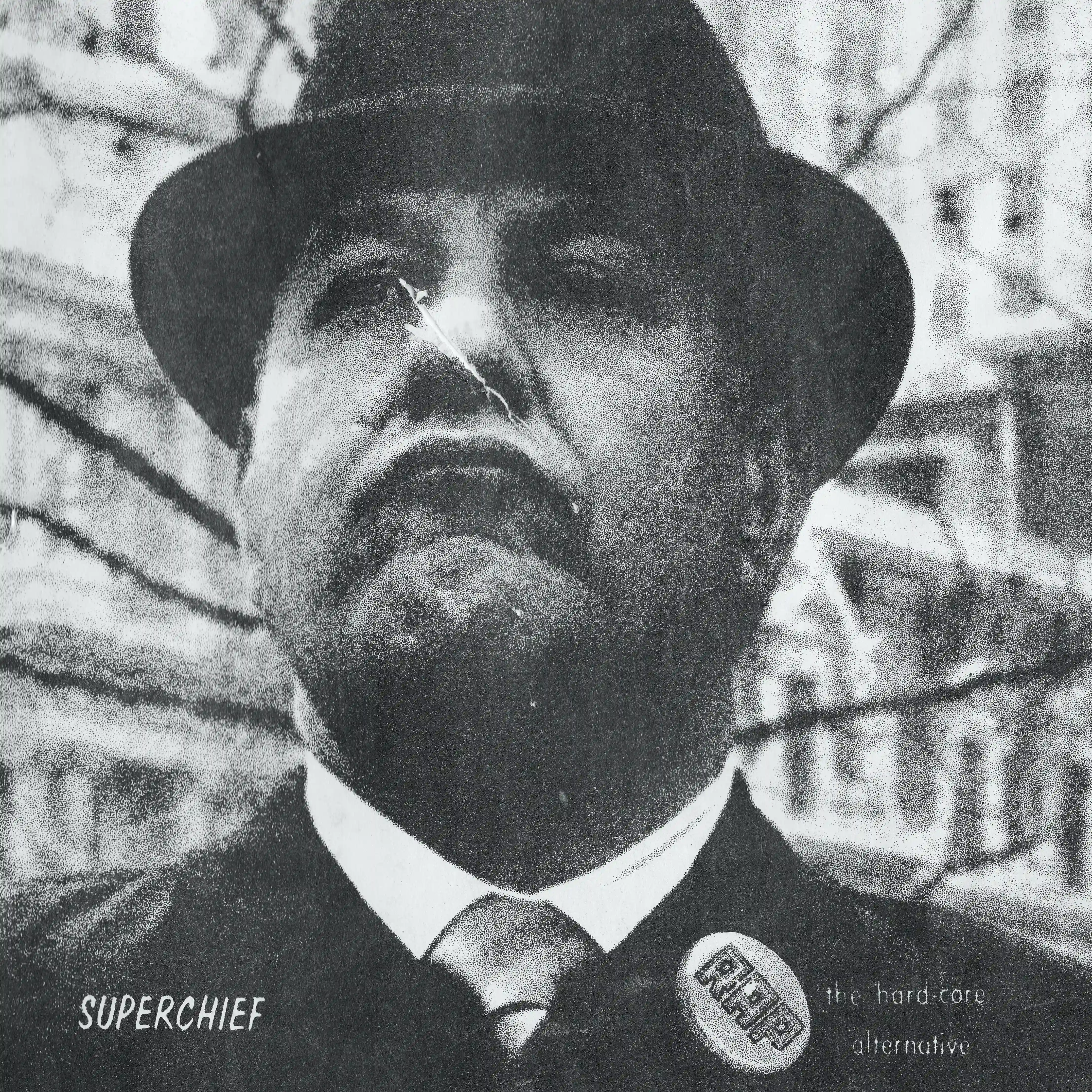 SUPERCHIEF - Figure in suit and hat with 'The hard-core alternative' button